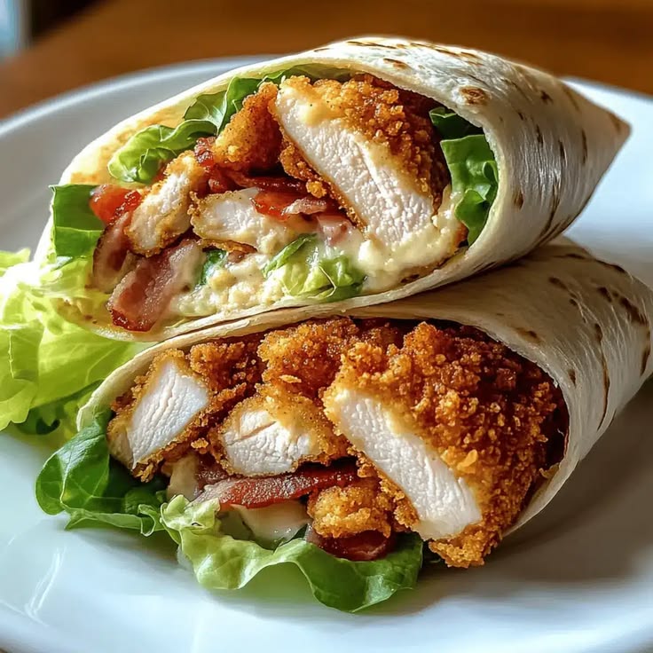 discover the ultimate crispy chicken club wrap, featuring golden fried chicken, smoky bacon, fresh veggies, and a creamy sauce, ready in no time!